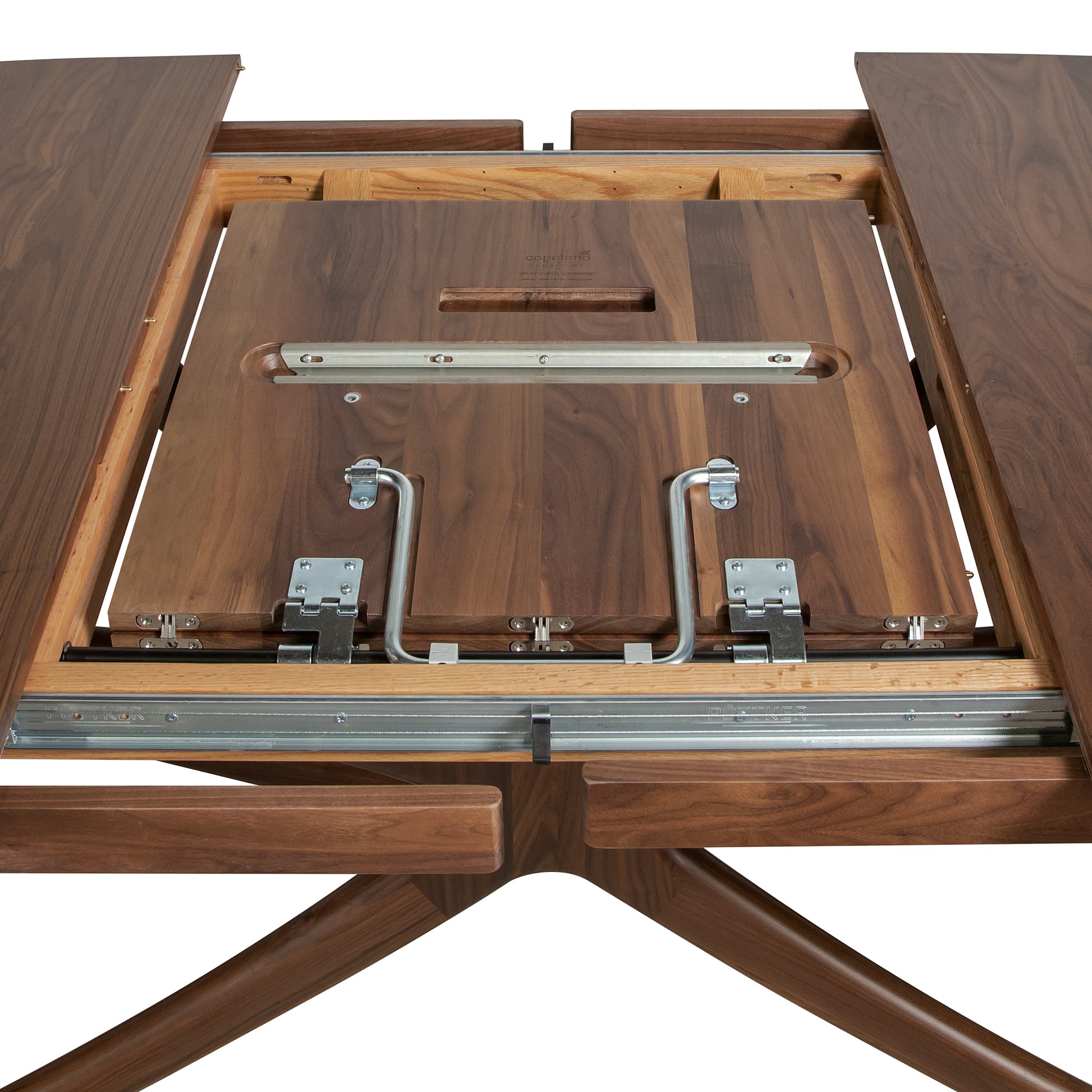 Copeland Furniture Butterfly Extension Dining Table in sustainable hardwood, featuring a visible metal sliding mechanism for easy extension.