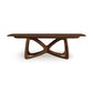 Alt text: Solid wood dining table from Copeland Furniture with modern design featuring a Butterfly Extension. The table has a rectangular top and unique intersecting curved supports forming an X-shaped base, made from sustainably sourced dark brown hardwoods. This American-made furniture piece represents high-quality craftsmanship in walnut wood.