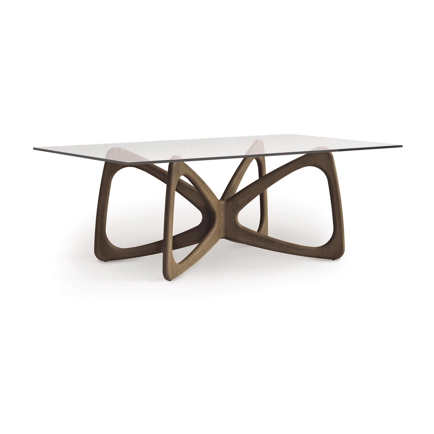 Introducing the Butterfly Glass Top Dining Table by Copeland Furniture, featuring a rectangular tempered glass top paired with a sculptural wooden base of interlocking curves. This modern piece combines contemporary elegance with a blend of transparency and sustainably sourced hardwoods.