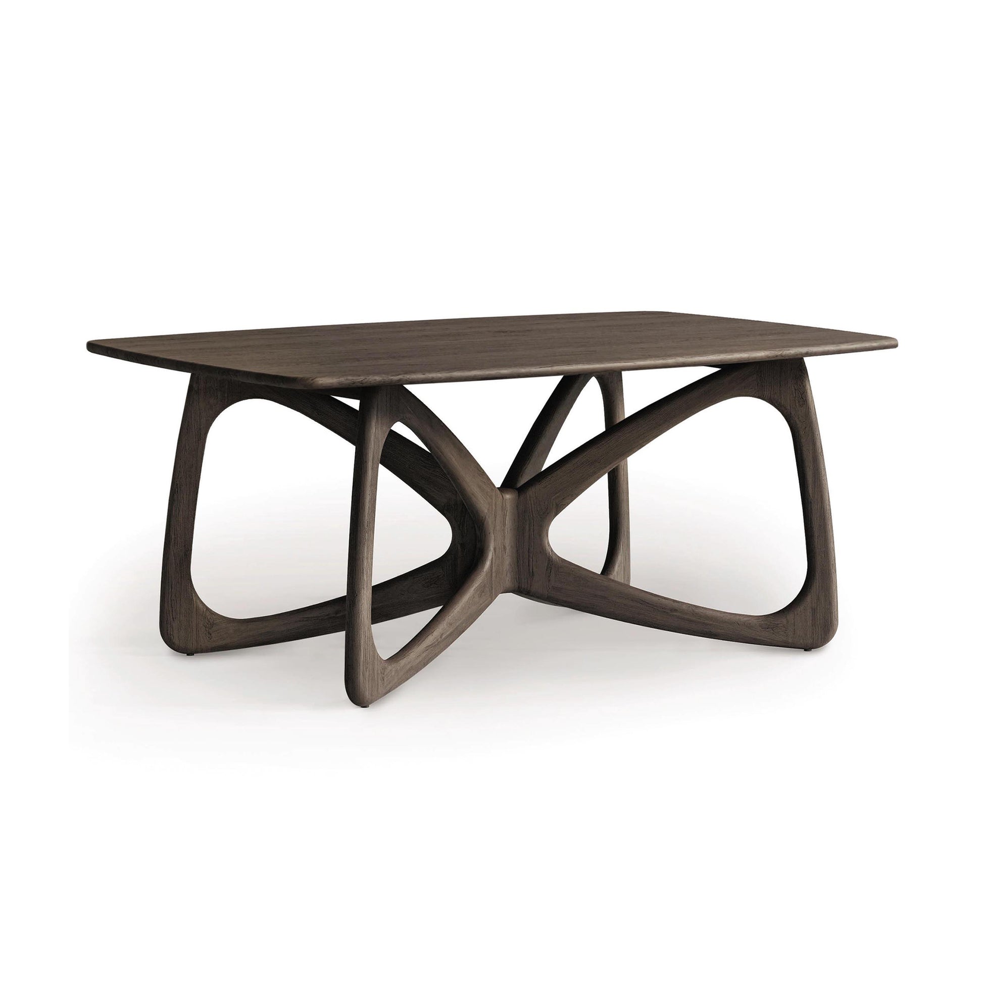 The Copeland Furniture Butterfly Solid Top Dining Table stands as a centerpiece of modern aesthetics, crafted from sustainably sourced hardwoods. Its rectangular design features a distinctive curved base with intersecting loops, elegantly set against a plain white background.