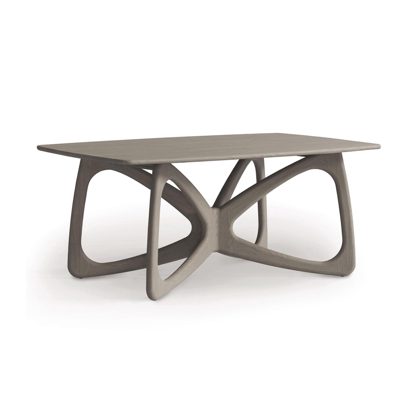 The Butterfly Solid Top Dining Table by Copeland Furniture is a modern wooden table with a rectangular top and an intricate geometric base design. Made from sustainably sourced hardwoods, its light natural finish beautifully contrasts against the plain white background.