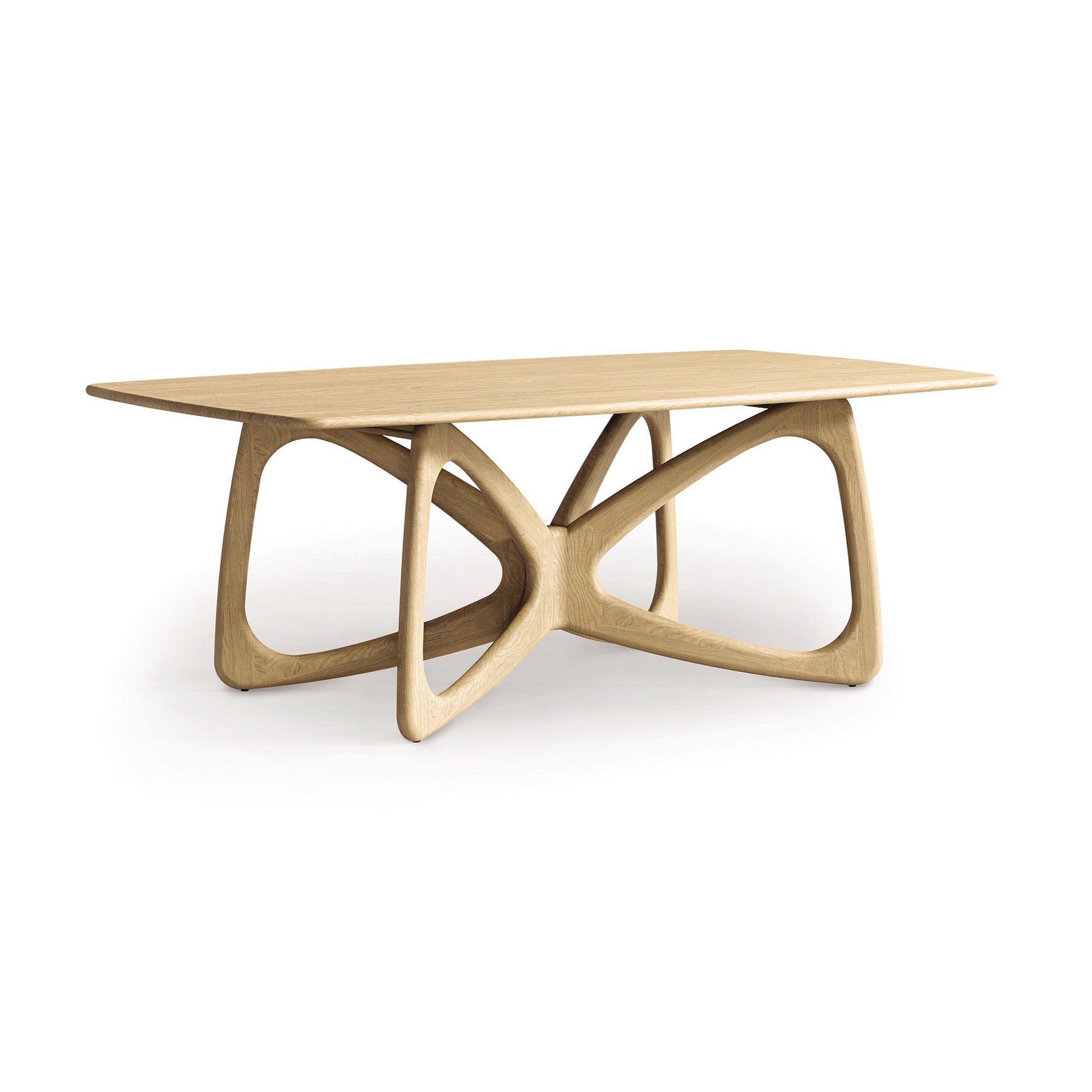 The Copeland Furniture Butterfly Solid Top Dining Table embodies contemporary design with its rectangular top and distinctive geometric legs. Made from sustainably sourced hardwoods, this table presents curved, interlocking shapes in a light wood finish against a simple white backdrop.