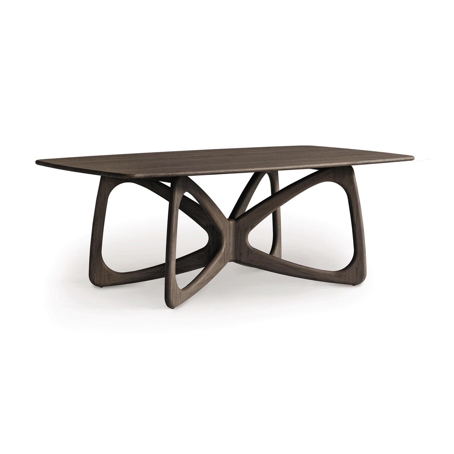 The Butterfly Solid Top Dining Table by Copeland Furniture features a rectangular wooden top with a distinctive, intertwined base design that exudes modern aesthetics against a plain white background. Made from sustainably sourced hardwoods, the table boasts a smooth finish and rich dark brown color.