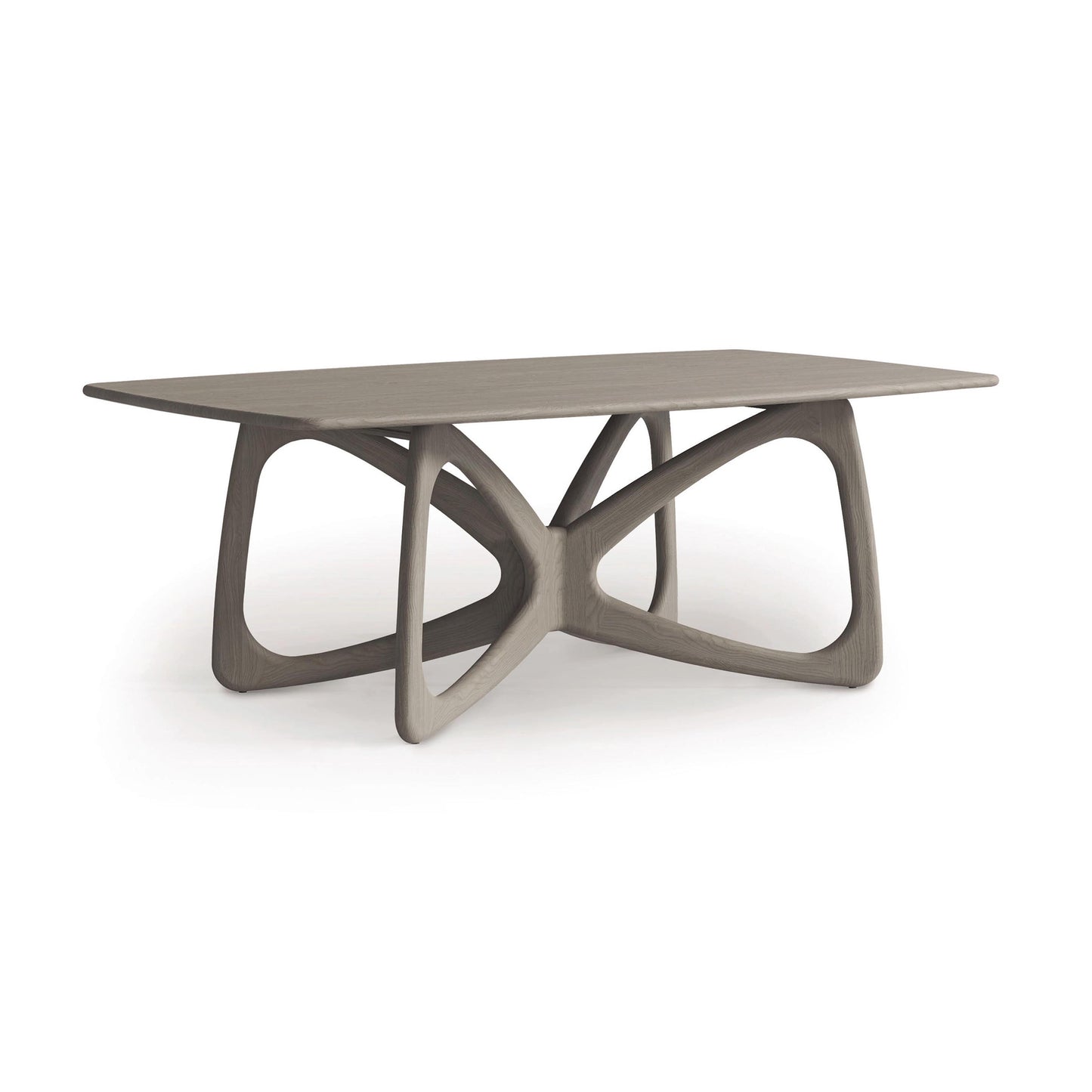 The Butterfly Solid Top Dining Table by Copeland Furniture features a rectangular top made from sustainably sourced hardwoods and is complemented by an intricately sculptural base of interlocking geometric shapes, making it a perfect embodiment of minimalist design.