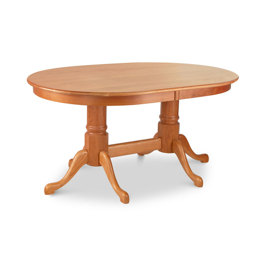 A Lyndon Furniture Cabriole Oval Double Pedestal Solid Top Table with four legs and claw foot.