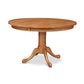A Cabriole Round Pedestal Dining Table with a traditional claw foot base crafted from North American hardwood by Lyndon Furniture.