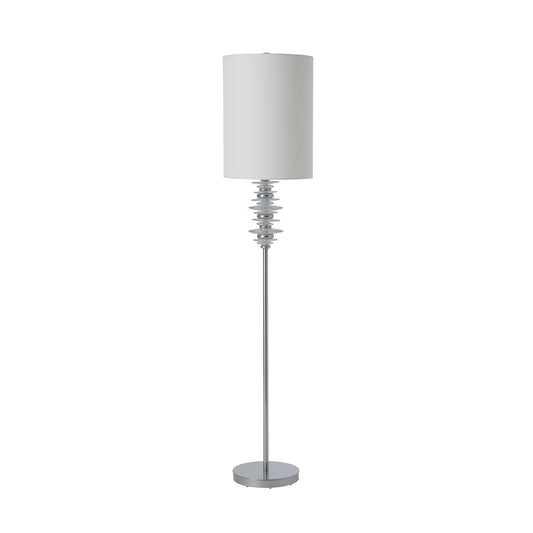 Cairn Floor Lamp by Hubbardton Forge with a white cylindrical shade, stacked silver rings, and round silver base; American made artisan lighting.