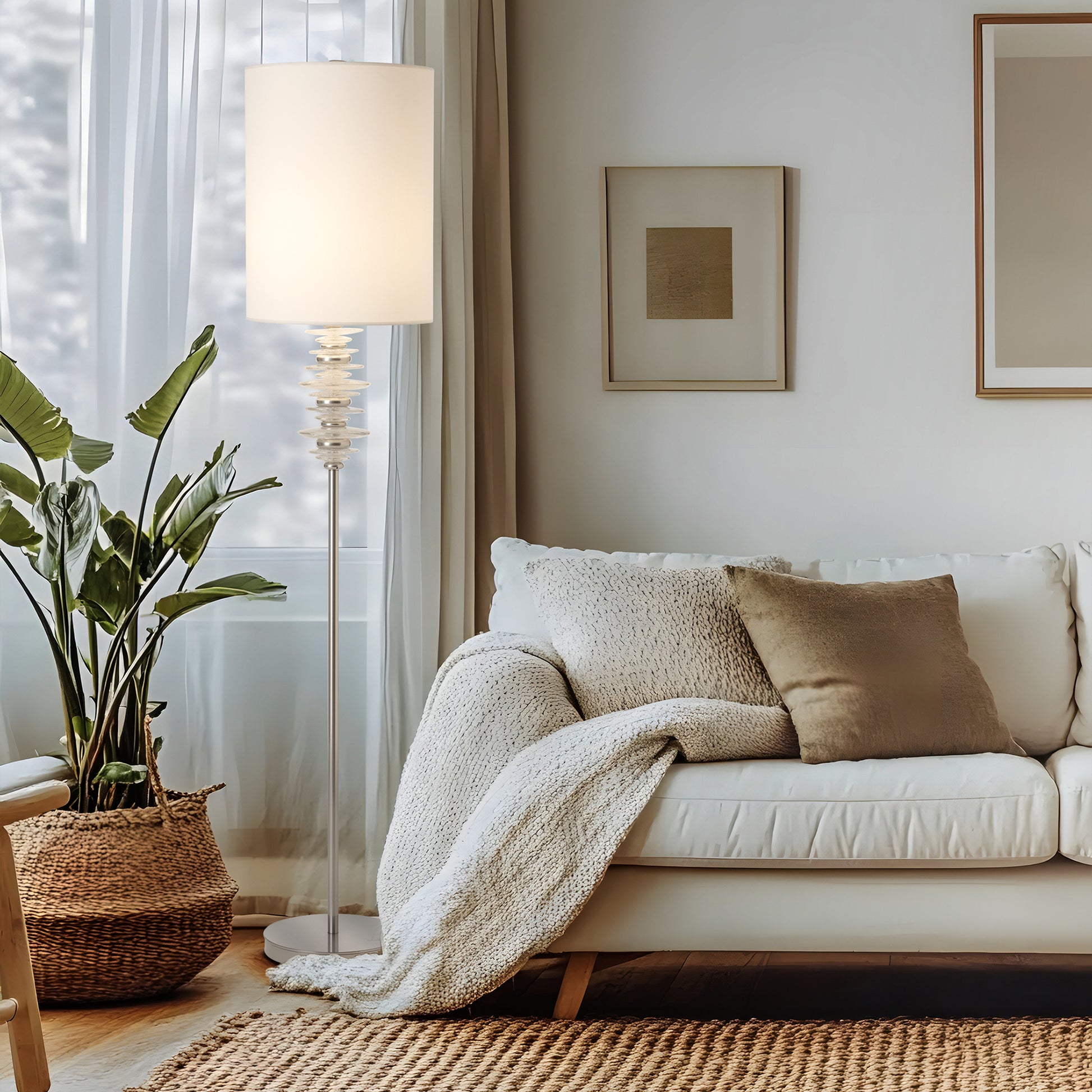 White sofa with beige pillows and the Hubbardton Forge Cairn Floor Lamp, showcasing American made living room furniture.