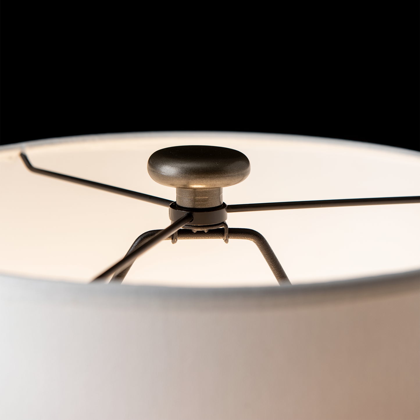 Cairn Table Lamp by Hubbardton Forge featuring detailed metal spokes and finial, highlighting American craftsmanship and furniture design.