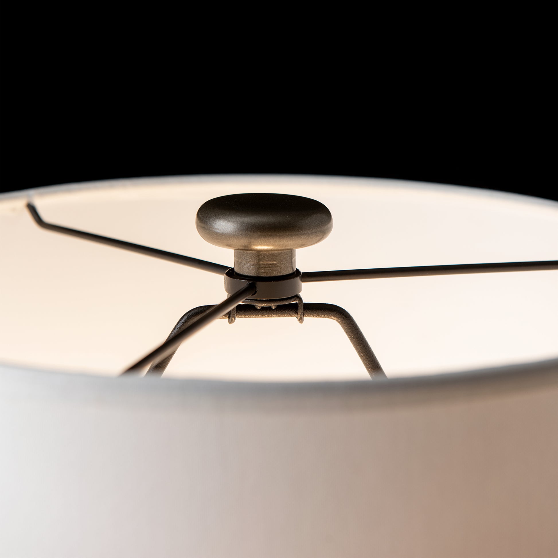 Cairn Table Lamp by Hubbardton Forge featuring detailed metal spokes and finial, highlighting American craftsmanship and furniture design.