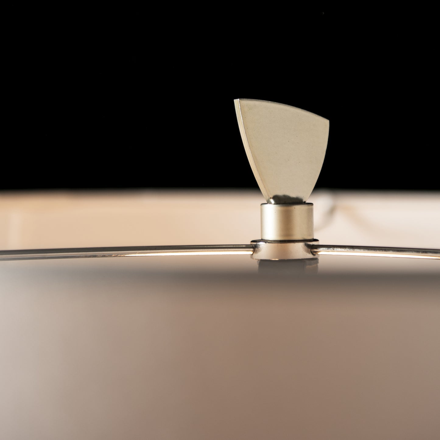 Hubbardton Forge Cambrian Table Lamp with a smooth, round surface and elegant metallic knob.