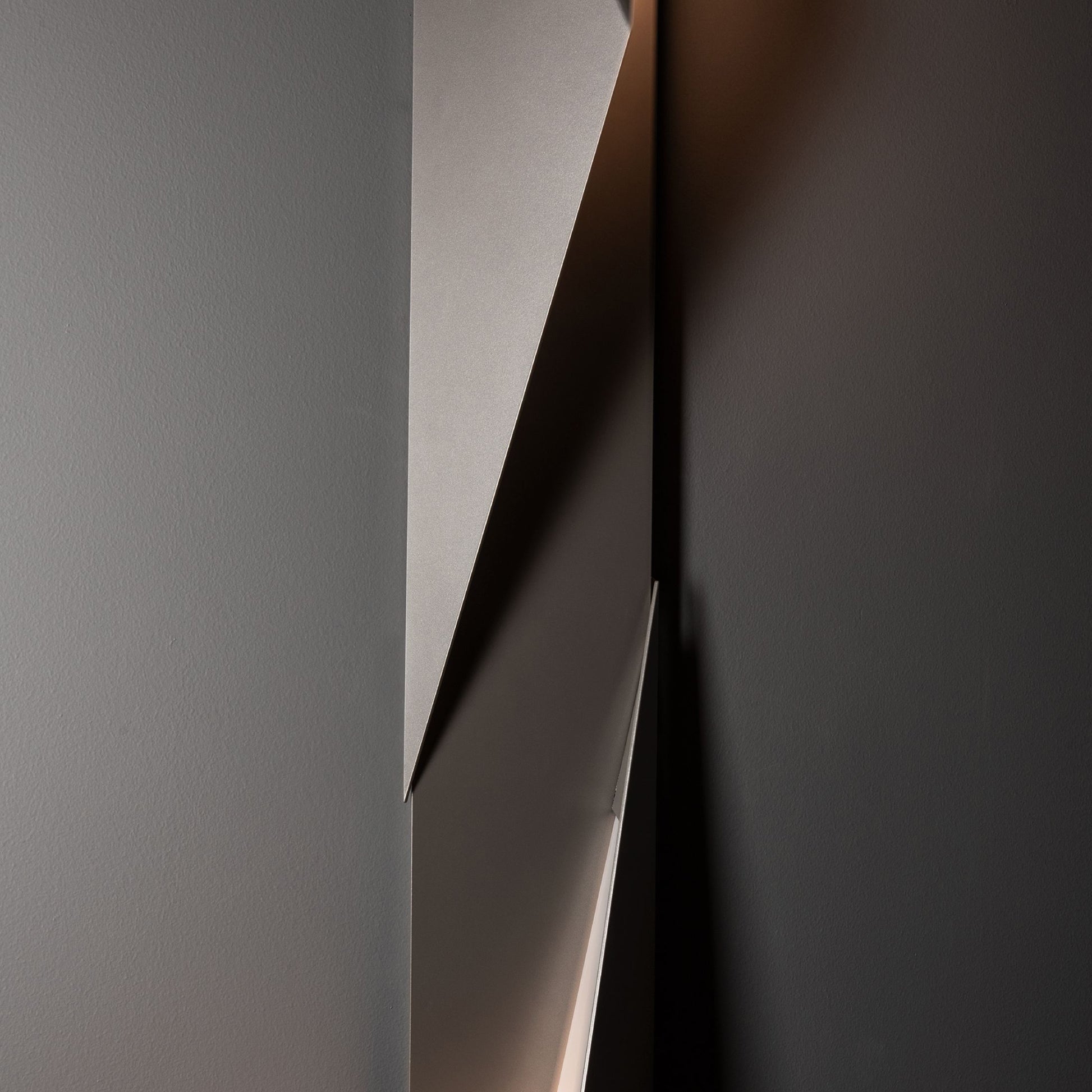 Close-up of the Hubbardton Forge Carbon Large Outdoor Sconce featuring two hand-forged steel panels with a sleek, modern design.