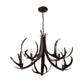 Hubbardton Forge Caribou 5-Light Chandelier featuring a modern, antler-inspired metal frame and five candelabra bulbs.
