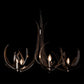 Caribou 5-Light Chandelier by Hubbardton Forge featuring dark, organic curved metal arms and five glowing candle-style bulbs.