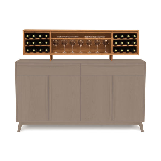 The Catalina 16" Buffet Hutch from Copeland Furniture features a wine rack that holds several bottles horizontally and showcases wine glasses upright. Made from sustainably harvested hardwoods, this luxury dining furniture piece boasts a simple, modern design with four doors.