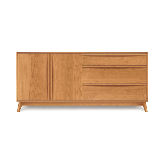 The Copeland Furniture Catalina 3-Drawer, 2-Door Dresser boasts a minimalist design inspired by mid-century modern style. It has two doors on the left and three drawers on the right, making it perfect for bedroom storage. Featuring a light brown finish and standing on four short legs, this wooden sideboard is an elegant addition to any room.