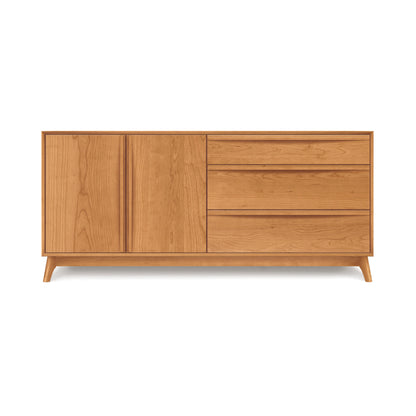 The Copeland Furniture Catalina 3-Drawer, 2-Door Dresser is a wooden sideboard with a natural finish, ideal for bedroom storage. It comes with two doors on the left and three drawers on the right, all elevated by four short legs that contribute to its unique mid-century modern charm.