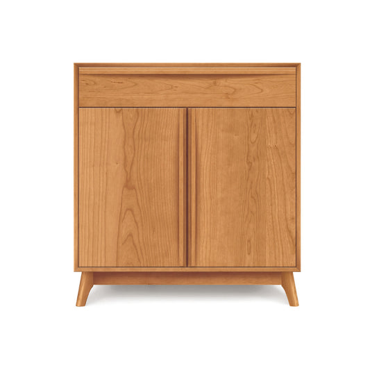 A Catalina 1-Drawer, 2-Door Buffet by Copeland Furniture with two doors on a plain background.