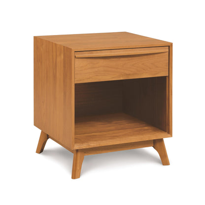 Solid wood Copeland Furniture Catalina 1-Drawer Enclosed Shelf Nightstand with a single drawer and an open lower shelf, on angled legs, against a white background.