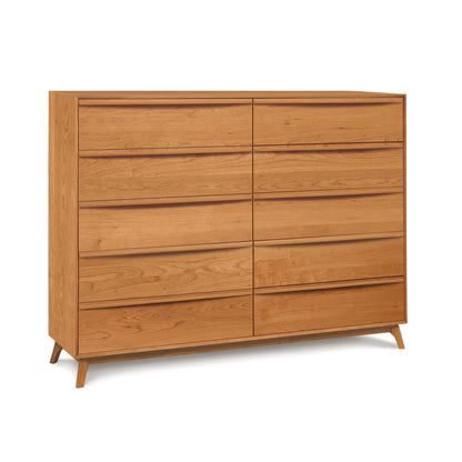 A Catalina 10-Drawer Dresser by Copeland Furniture, with six drawers and slanted legs, featuring natural cherry, on a white background.