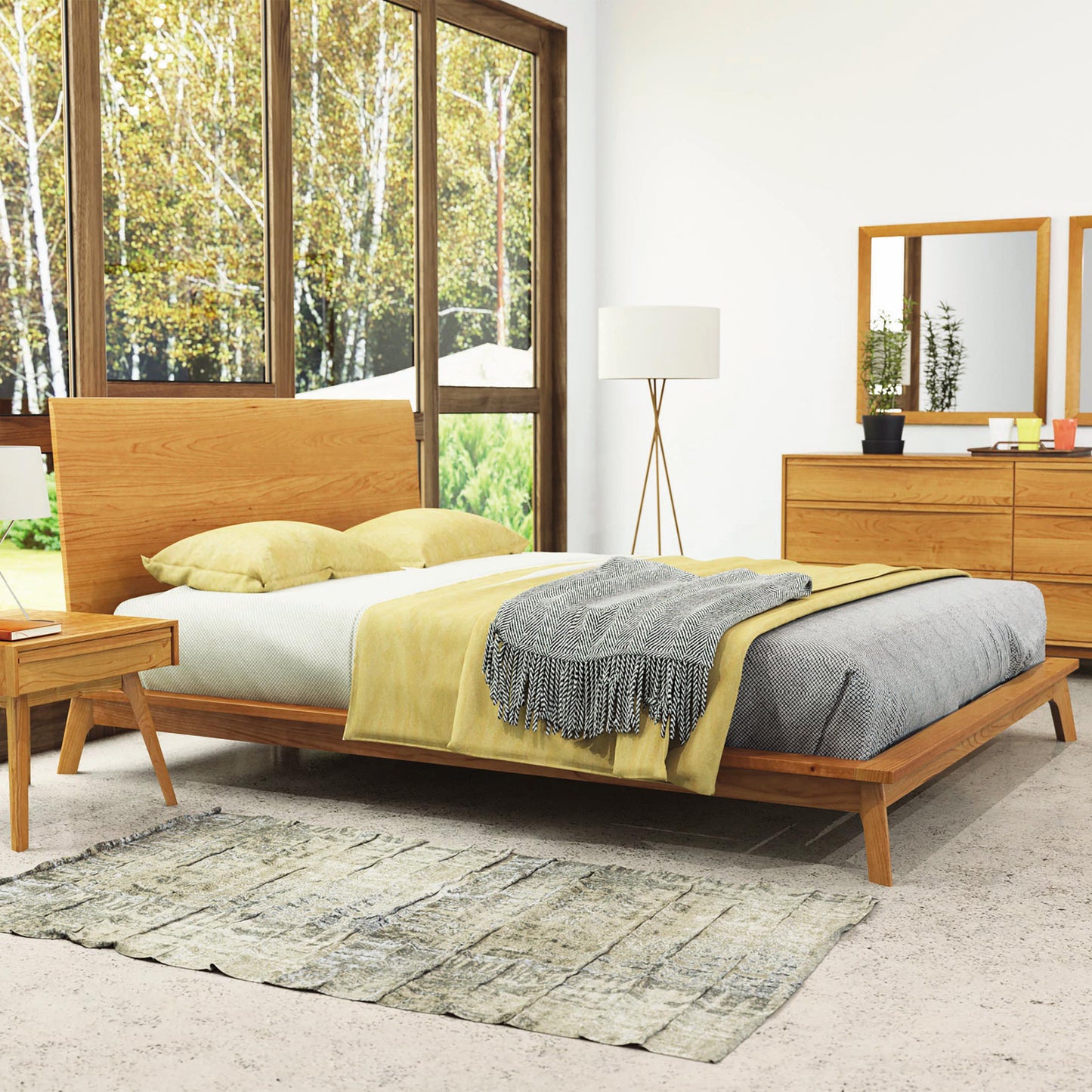 Copeland Catalina Platform Bed with gray/yellow bedding, paired with a side table and mirrored dresser.