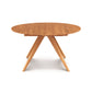 Round Catalina Round Extension Table, crafted from solid North American wood with a symmetrical cross base, isolated on a white background.
