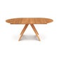 A solid North American wood Catalina Round Extension Table with a smooth surface and four angled legs, isolated on a white background. Brand: Copeland Furniture