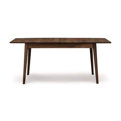 Copeland Furniture Catalina Extension Table shown in dark brown solid wood, featuring a sleek Mid-Century design with four legs.