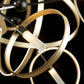 A close up of a Hubbardton Forge Celesse Pendant, featuring a stunning combination of gold and black colors.
