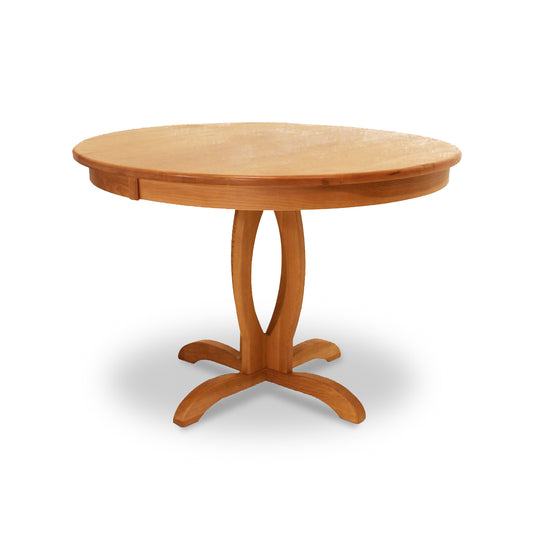 A Cherry Blossom Single Pedestal Round Table by Lyndon Furniture, with a natural wood finish and a wooden base, making it a solid wood pedestal dining table.