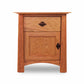 A Maple Corner Woodworks Cherry Moon 1-Drawer Nightstand With Door with a smooth finish, featuring one drawer and a cabinet door, set against a white background. This nightstand has a simple, modern design with round black handles.