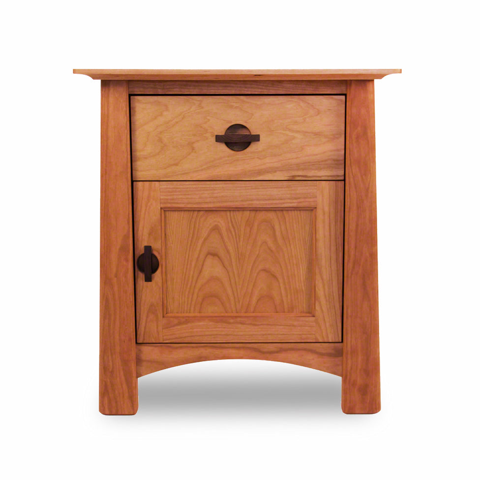 Cherry Moon 1-Drawer Nightstand with Door by Maple Corner Woodworks, featuring a natural finish that highlights the beautiful grain of solid cherry wood. This eco-friendly Vermont-made furniture piece has a single drawer and cabinet door with black metal handles, exemplifying sustainable American craftsmanship. Ideal for those seeking high-quality cherry wood furniture from an American manufacturer.