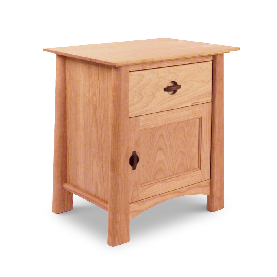 A Cherry Moon 1-Drawer Nightstand With Door crafted by Maple Corner Woodworks, featuring a single drawer with a leaf-shaped handle and a cabinet below with a matching leaf-shaped cutout. This piece has a rectangular top and.