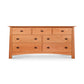 Cherry Moon 7-Drawer Dresser by Maple Corner Woodworks made from eco-friendly cherry wood with elegant metal handles.