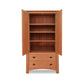 Maple Corner Woodworks Cherry Moon Armoire with open doors revealing shelves and a lower drawer, isolated on a white background.