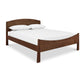 An eco-friendly Cherry Moon Bed with a Maple Corner Woodworks wooden headboard and footboard, handmade from solid wood.