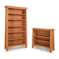 Two empty Maple Corner Woodworks Cherry Moon Bookcases of different sizes, crafted from sustainably harvested hardwoods, isolated on a white background.