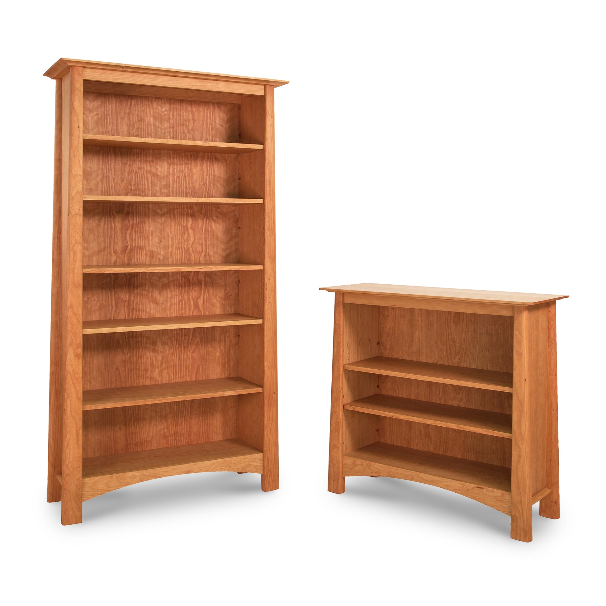 Two empty Maple Corner Woodworks Cherry Moon Bookcases of different sizes, crafted from sustainably harvested hardwoods, isolated on a white background.