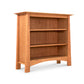 Cherry Moon Bookcase by Maple Corner Woodworks showcasing three shelves and a distinctive curved bottom, crafted from sustainably harvested hardwoods with a smooth white finish.