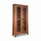 Cherry Moon Bookcase by Maple Corner Woodworks, handmade in Vermont from sustainable cherry, with glass doors, five shelves, and four sturdy legs.
