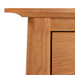 Close-up of a Cherry Moon File Cabinet corner from Maple Corner Woodworks showing detail of the wood grain and joinery.