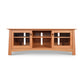 Cherry Moon 68" TV Console by Maple Corner Woodworks, crafted in natural cherry with glass-paneled cabinet doors and middle open shelves, showcasing elegant and functional Vermont-made design.