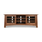 Cherry Moon 68″ TV console by Maple Corner Woodworks with glass doors, open shelves, and a natural cherry finish. American made craftsmanship.