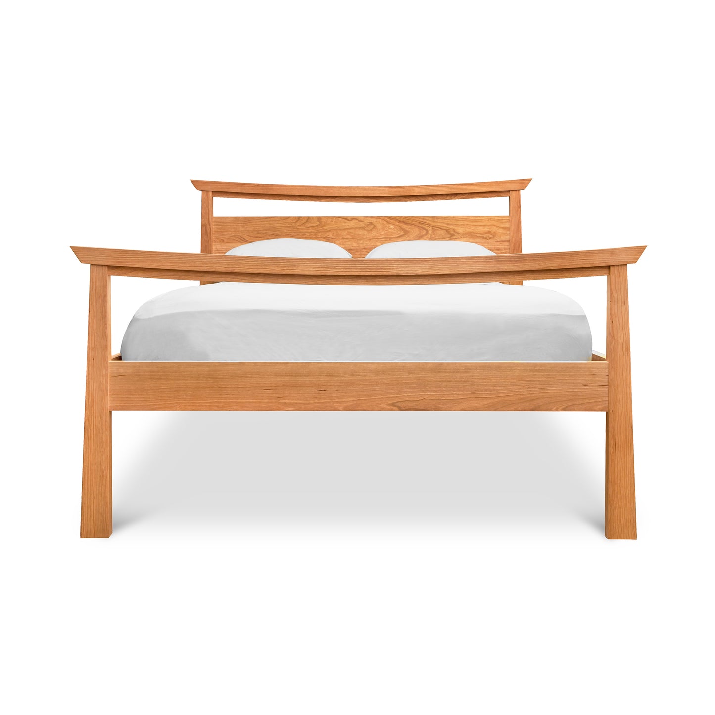 A modern bench made from natural cherry hardwood with a curved backrest and a white cushion, isolated on a white background, the Cherry Moon Pagoda Bed by Maple Corner Woodworks.