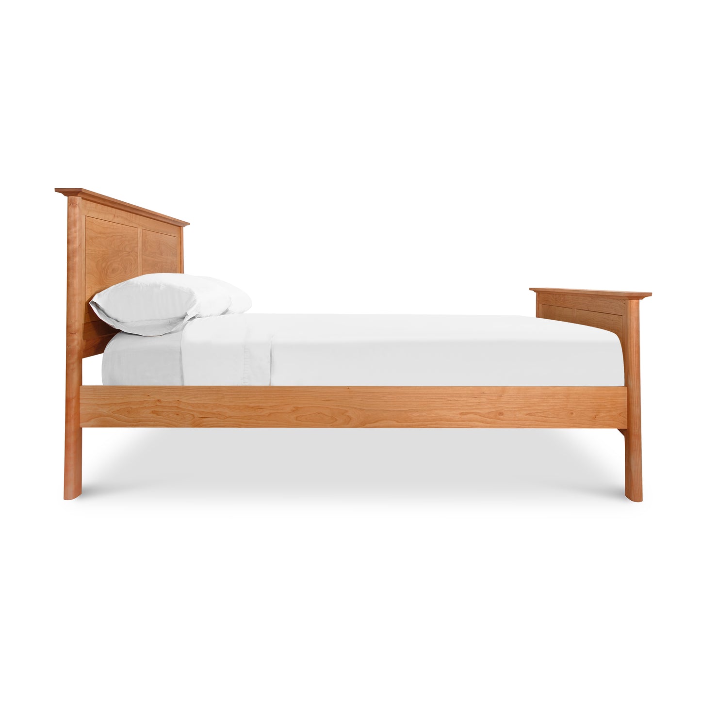 A single Cherry Moon Panel Bed from Maple Corner Woodworks with a curved headboard and footboard, featuring crisp white bedding and one white pillow, isolated on a white background.