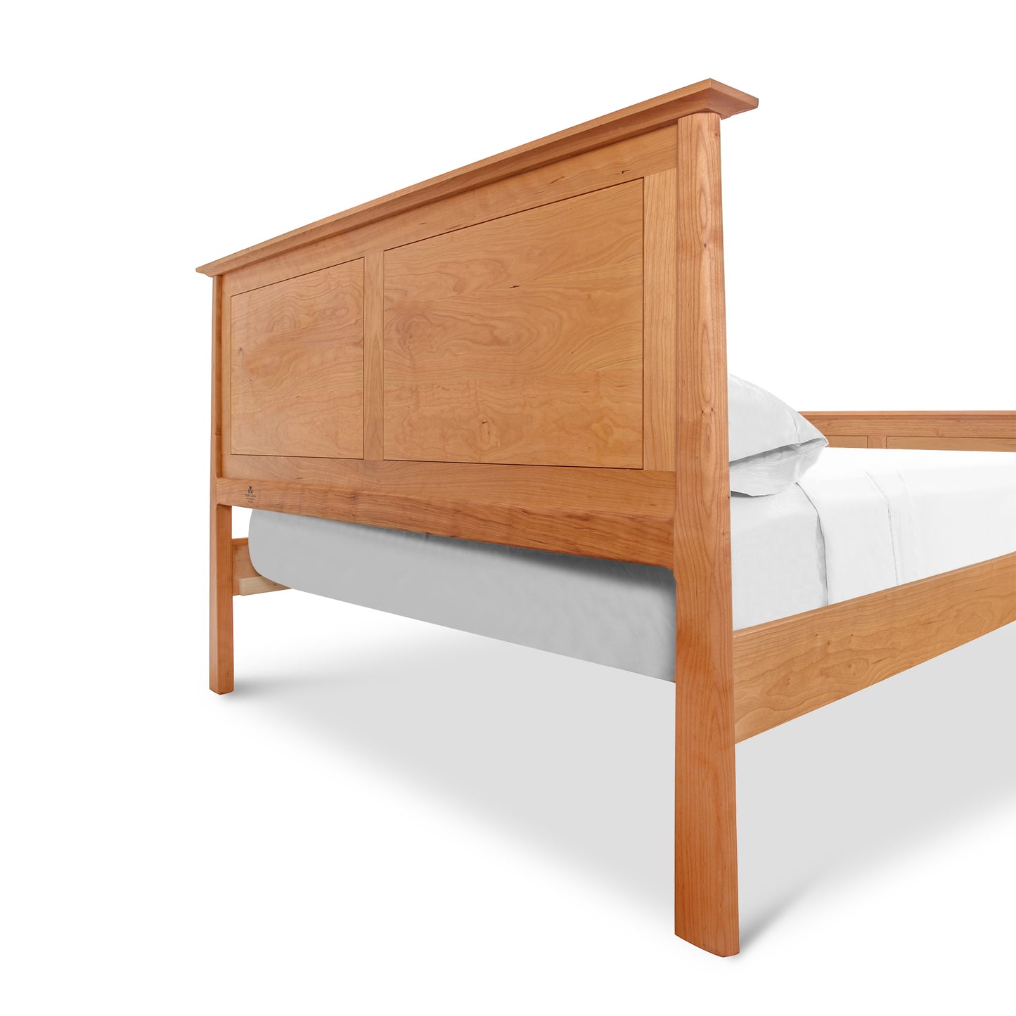 A Cherry Moon Panel Bed from Maple Corner Woodworks with a high rectangular headboard, showcasing a smooth finish and visible wood grain. The bed is partially dressed with a plain gray fitted sheet, set against a natural cherry background.