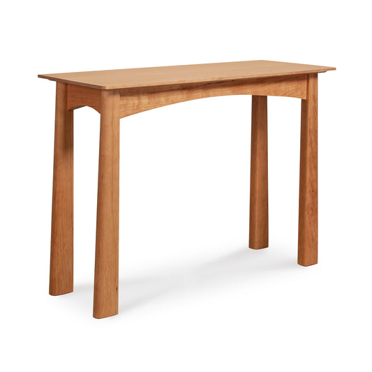 A simple American-made Cherry Moon Sofa Table by Maple Corner Woodworks with four legs and a rectangular top, isolated on a white background.