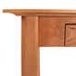 A close up of the Maple Corner Woodworks Cherry Moon Writing Desk with a drawer.