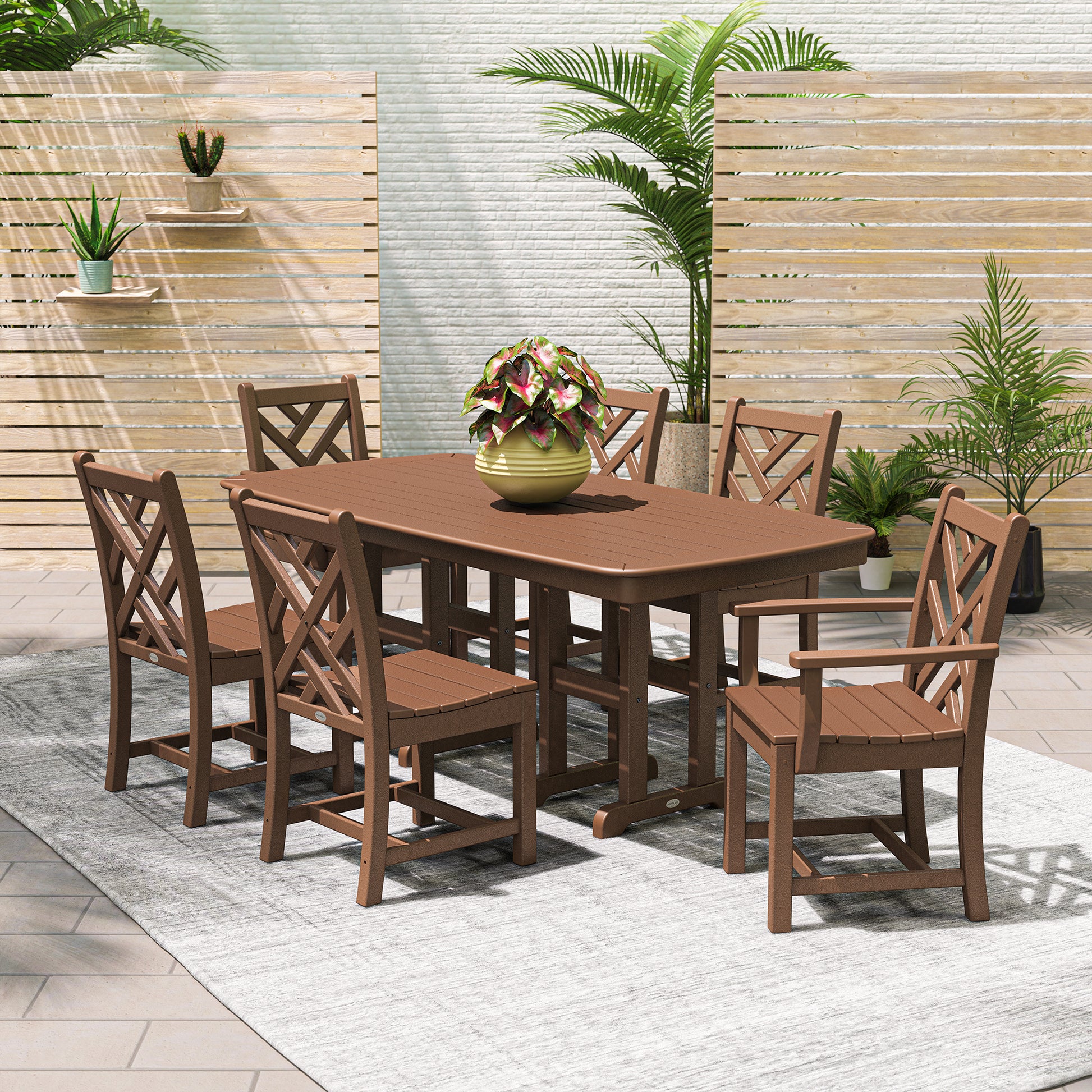 Six POLYWOOD Chippendale Outdoor Dining Chairs surround a brown patio table, showcasing durable, American-made outdoor furniture craftsmanship.