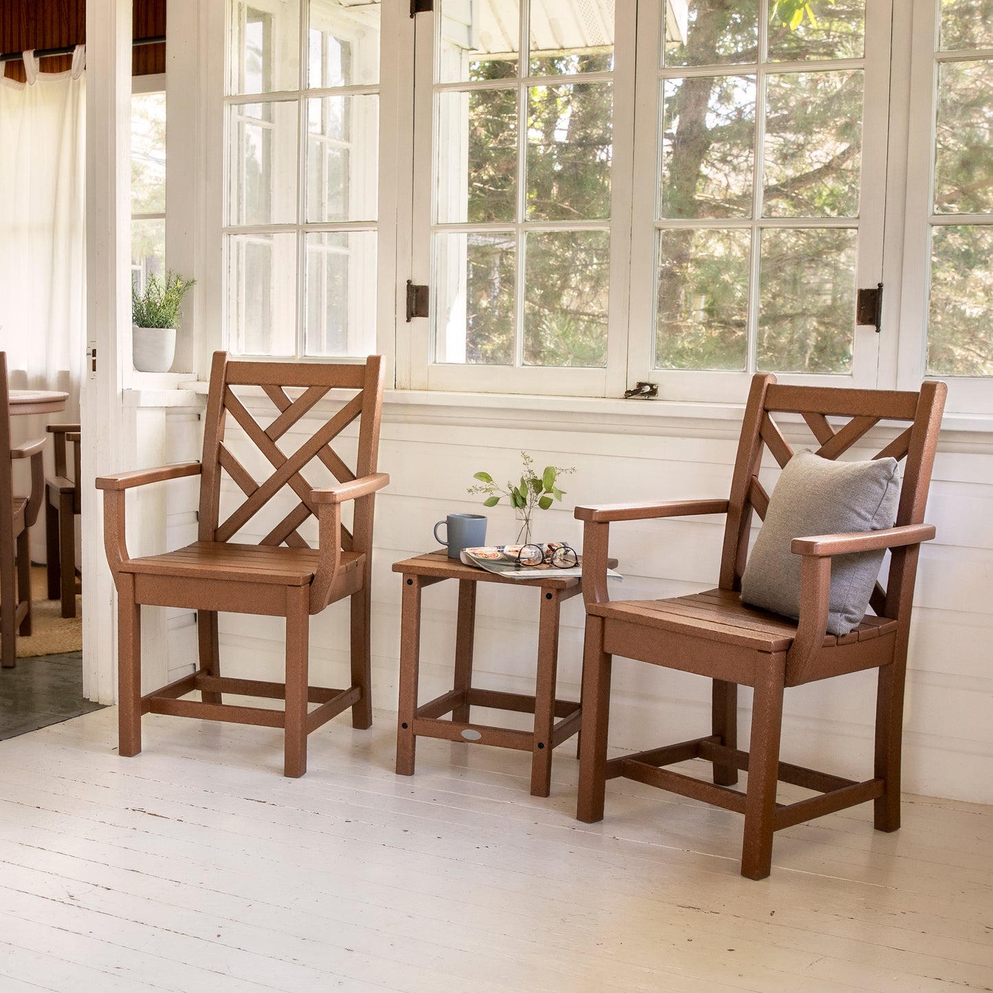 Two POLYWOOD Chippendale chairs with a side table displaying a mug and glasses.